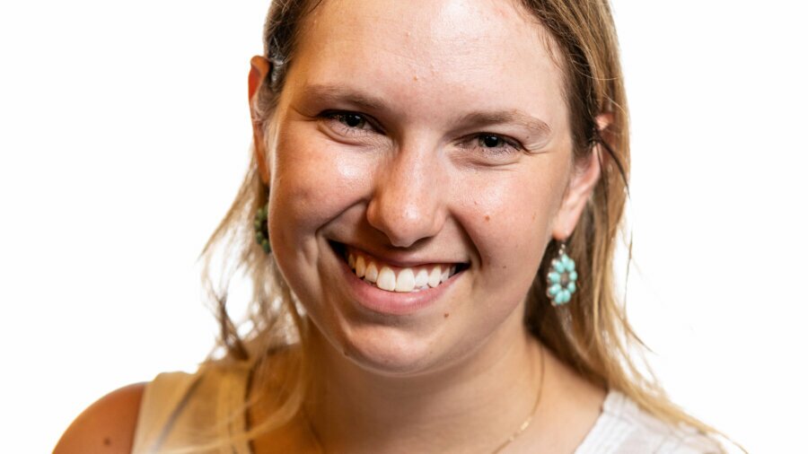 Rebecca Langbein smiling headshot wearing a white sleeveless top