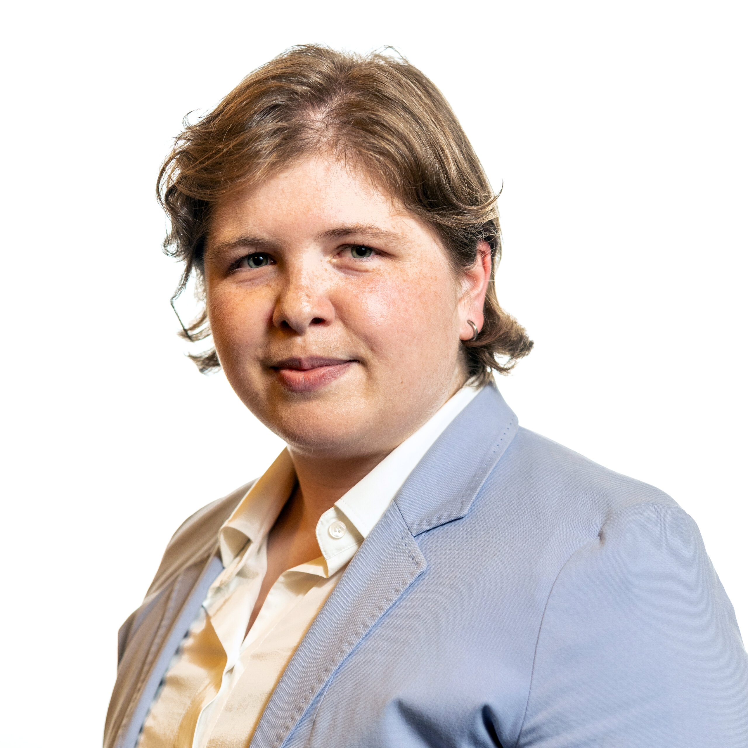 Theresa Soares smiling headshot wearing a light blue suit