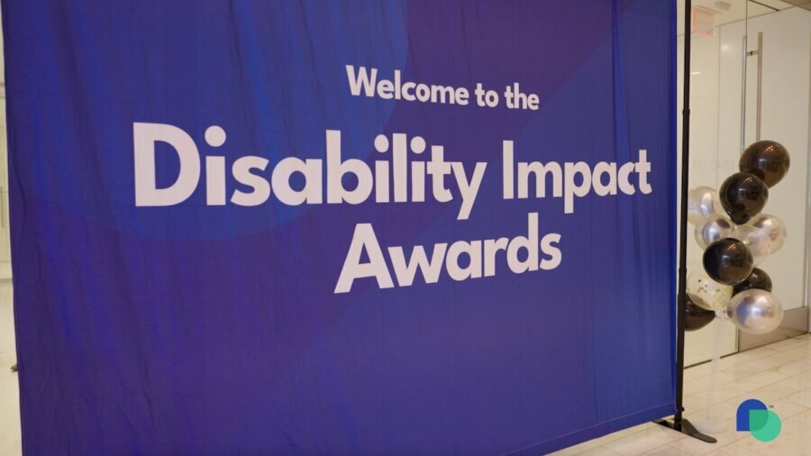 Welcome sign outside of the Disability Impact Awards in D.C. surrounded by balloons. Disability Belongs logo in bottom right of image