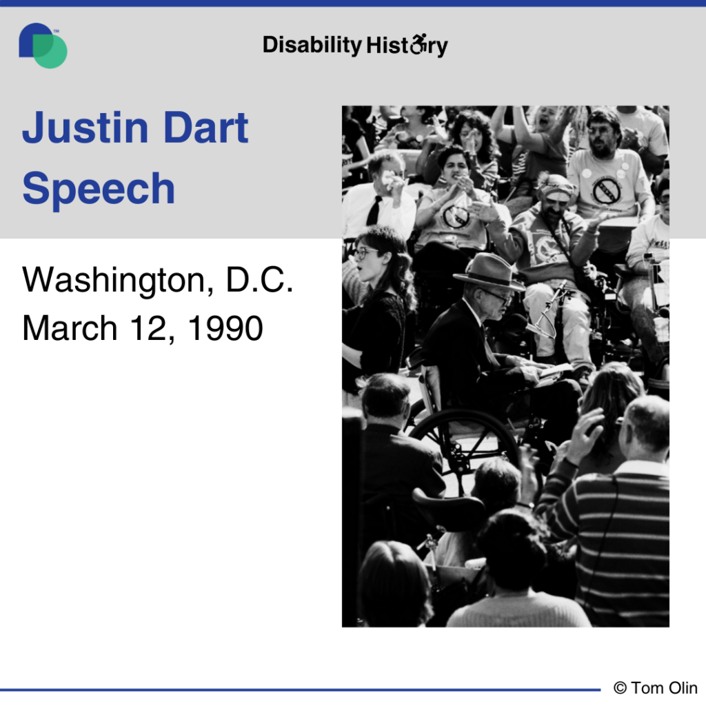 Black and white photo of Justin Dart giving a speech surrounded by a crowd of protesters; many in wheelchairs. Text: Justin Dart Speech. Washington, D.C. March 12, 1990. Source: Tom Olin.
