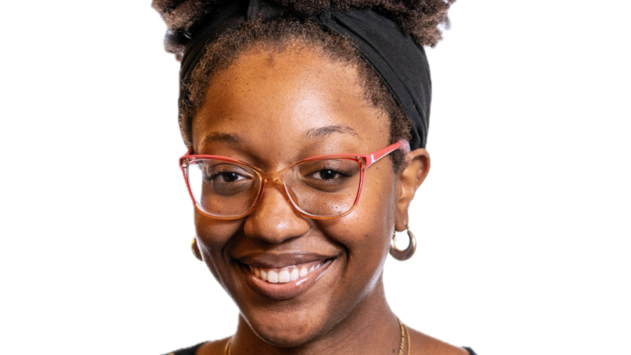 Ashley Nyaley smiling headshot wearing a blue sleeveless top with white polka dots