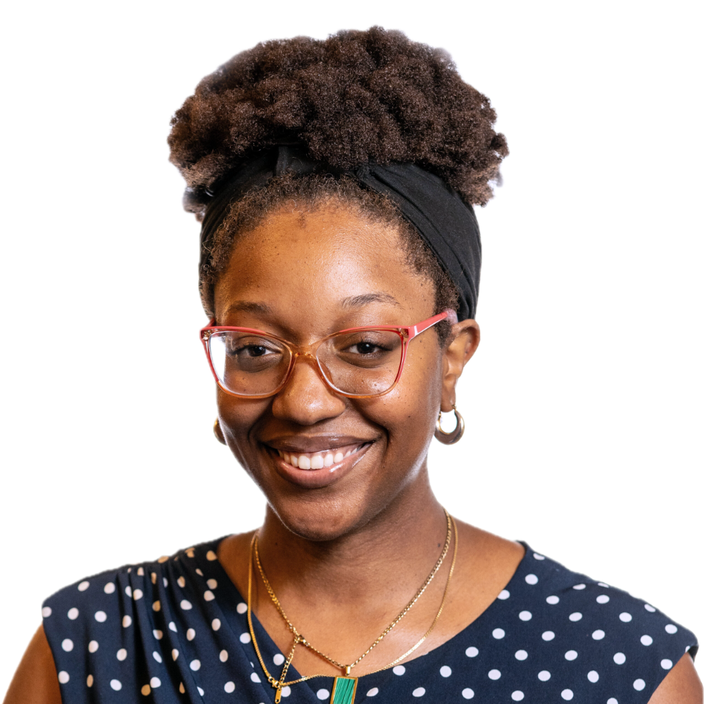 Ashley Nyaley smiling headshot wearing a blue sleeveless top with white polka dots