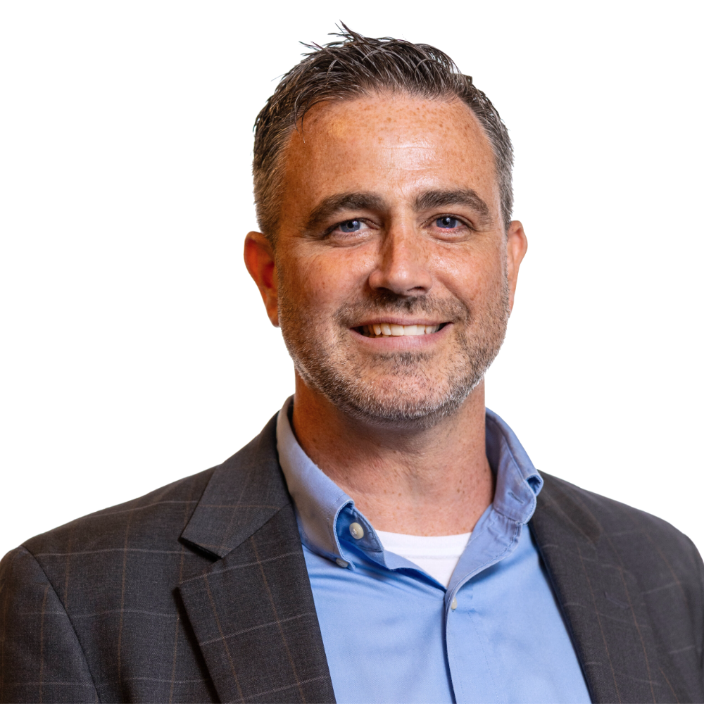 Kevin McCloskey smiling headshot wearing a grey blazer and blue dress shirt