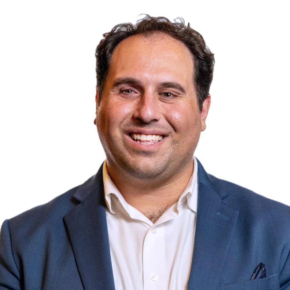 Rostom Dadian smiling headshot wearing a navy blue blazer