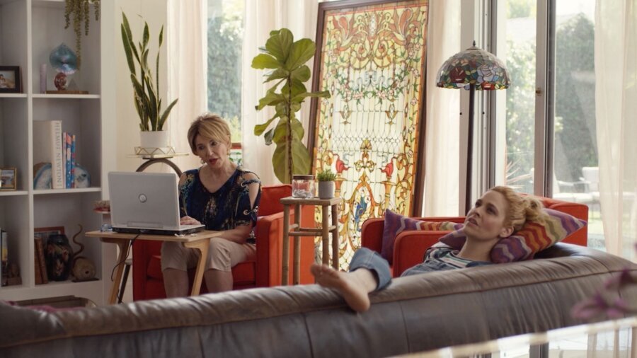 A scene from Bulldozer with the protagonist Jo lying on a couch while speaking with someone seated behind a laptop