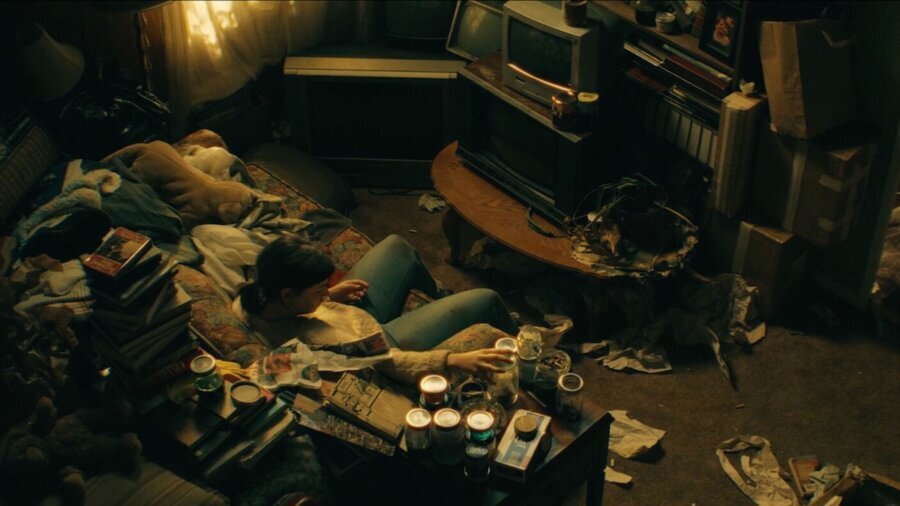 Still from The Things We Keep showing the busy apartment of a hoarder with stuff everywhere