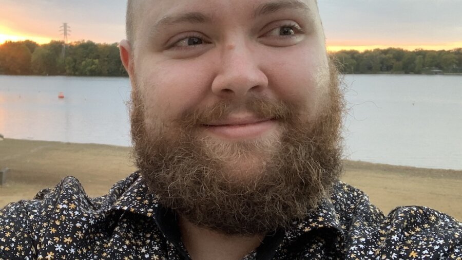 Allen Martsch smiling in front of a large body of water