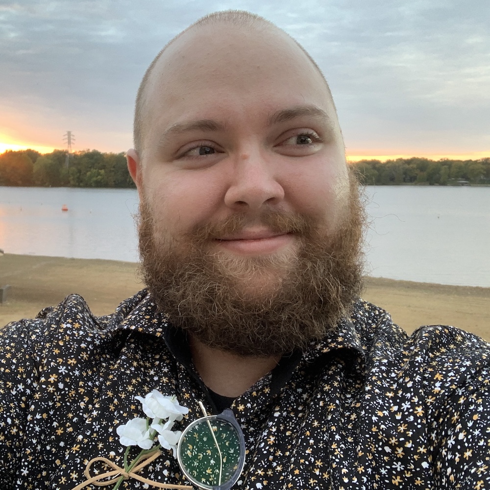 Allen Martsch smiling in front of a large body of water