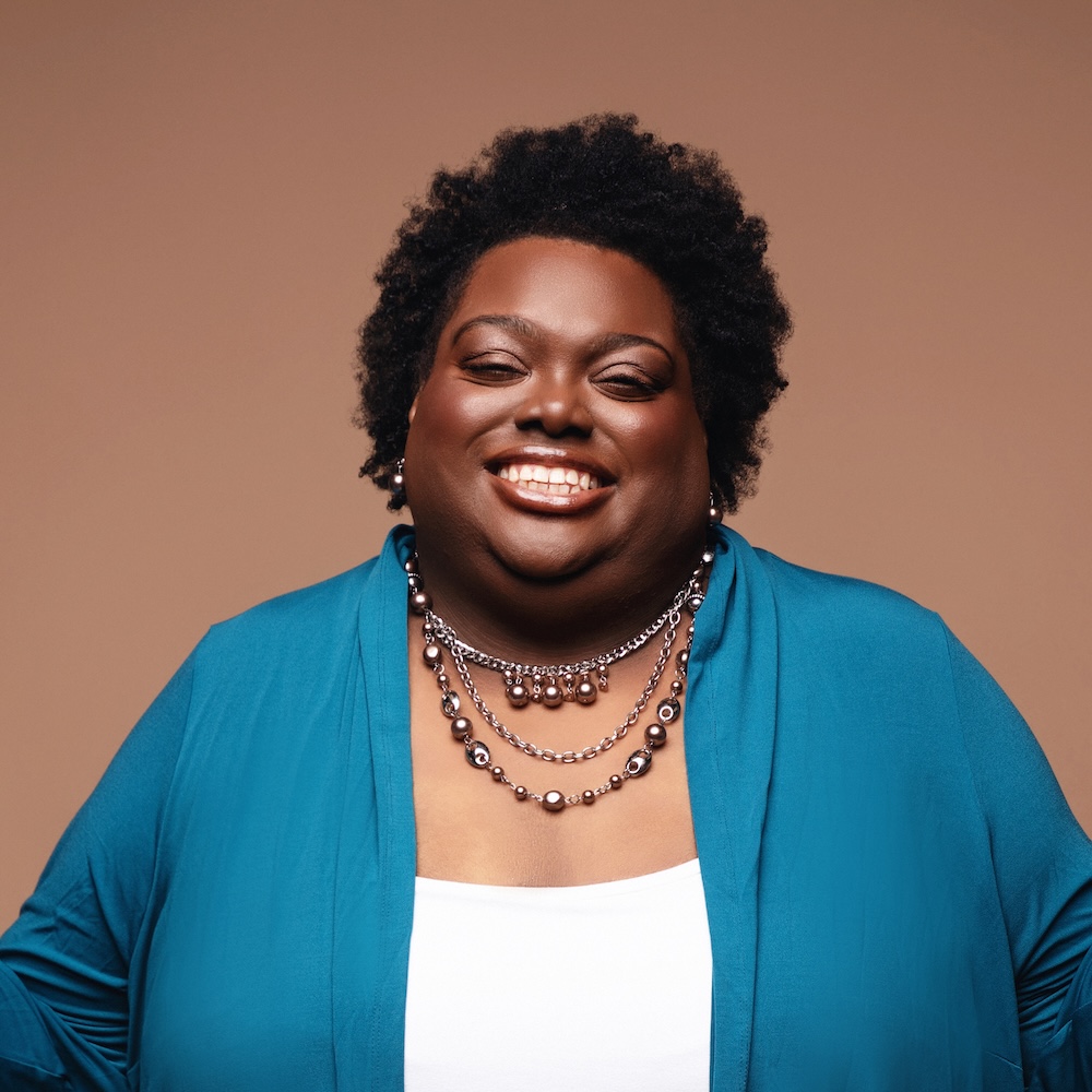 Allison Hampton smiling headshot wearing a blue blazer
