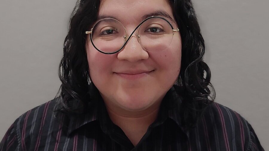 Felix Moreno smiling headshot wearing glasses and a dress shirt