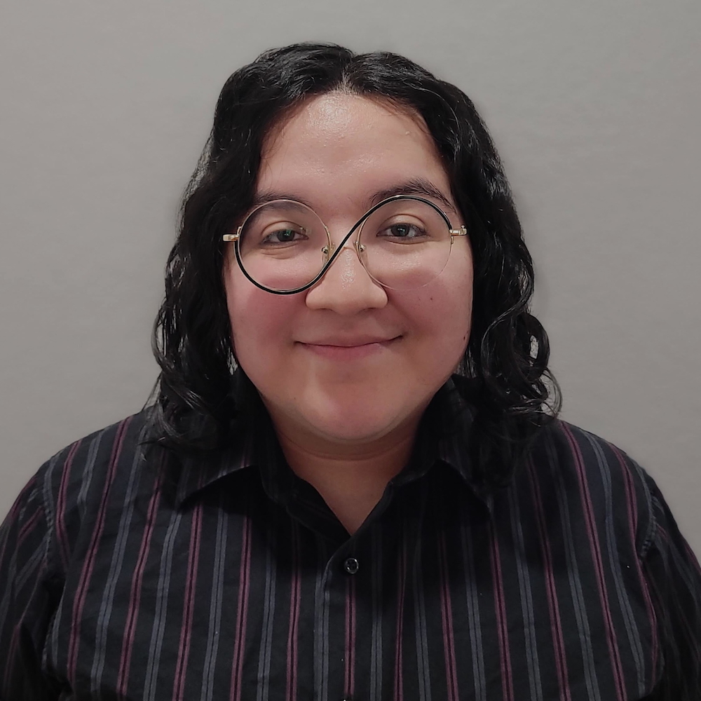 Felix Moreno smiling headshot wearing glasses and a dress shirt