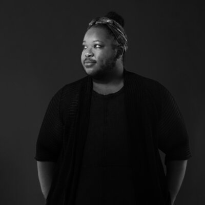 Azure D. Osborne-Lee greyscale headshot wearing a black shirt