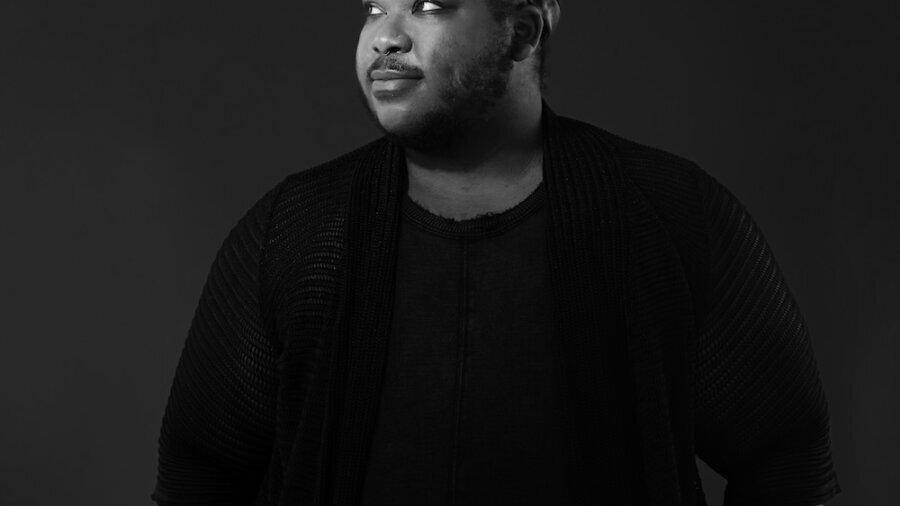 Azure D. Osborne-Lee greyscale headshot wearing a black shirt