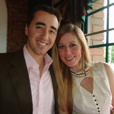 Cat Youell and Brad Crowe smiling together in formal clothing