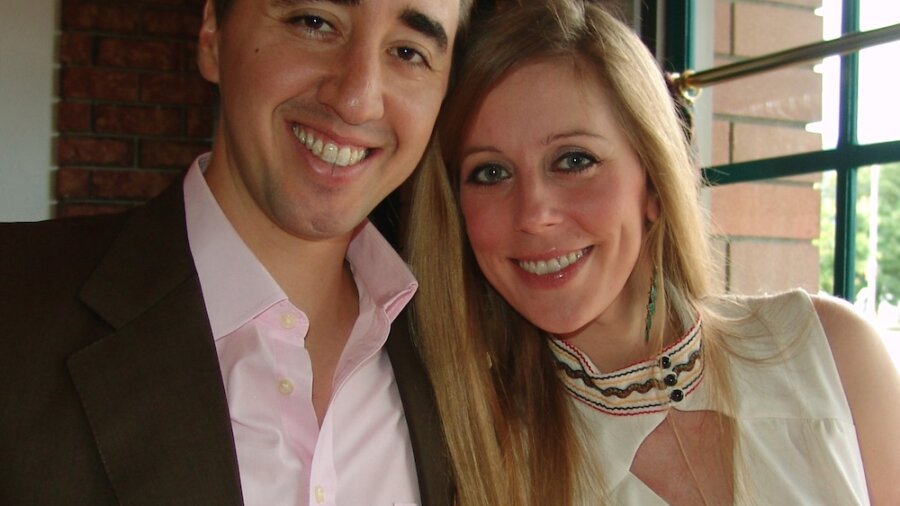 Cat Youell and Brad Crowe smiling together in formal clothing