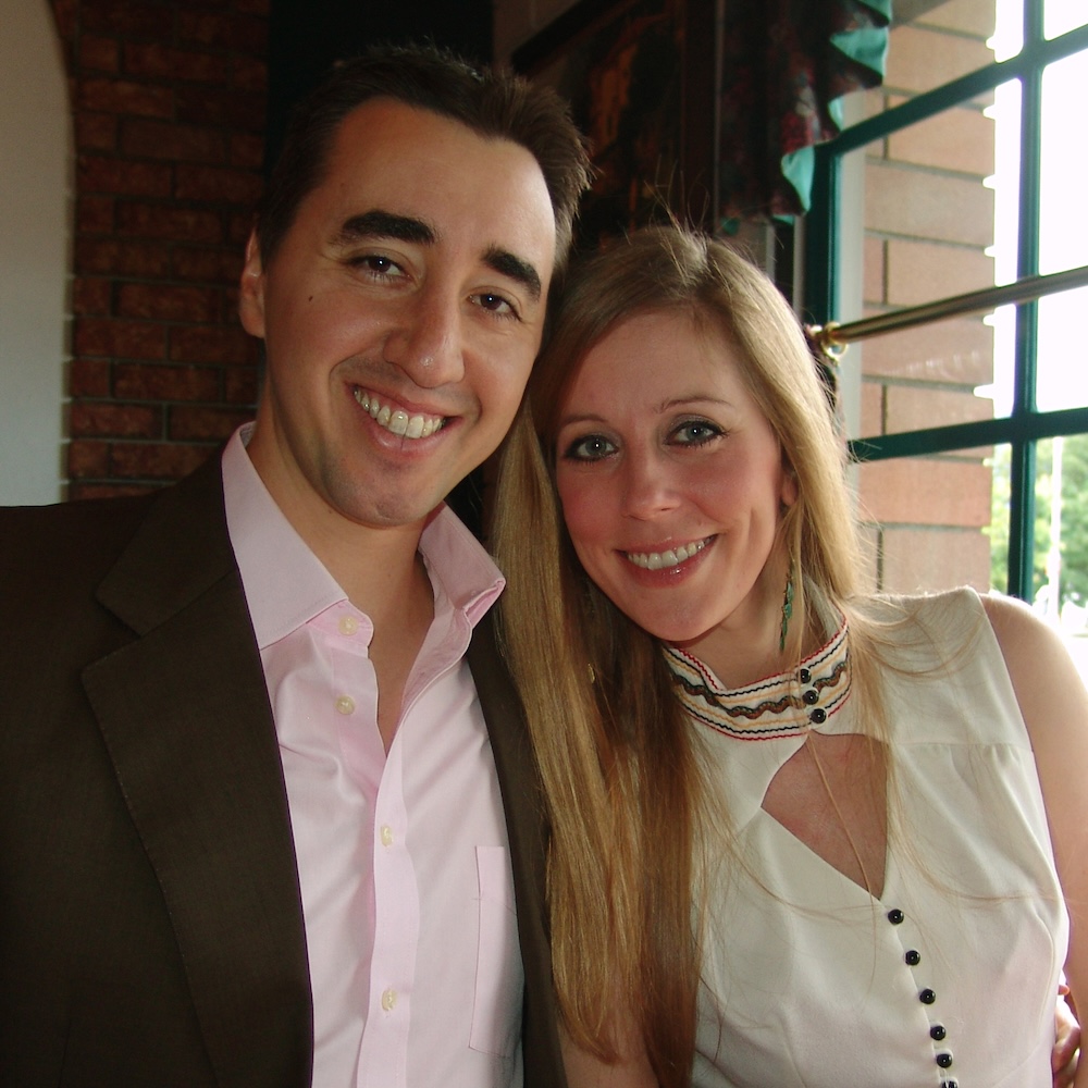 Cat Youell and Brad Crowe smiling together in formal clothing