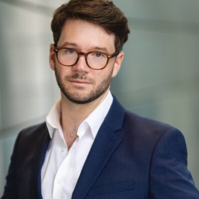 James Caverly headshot wearing a blue blazer