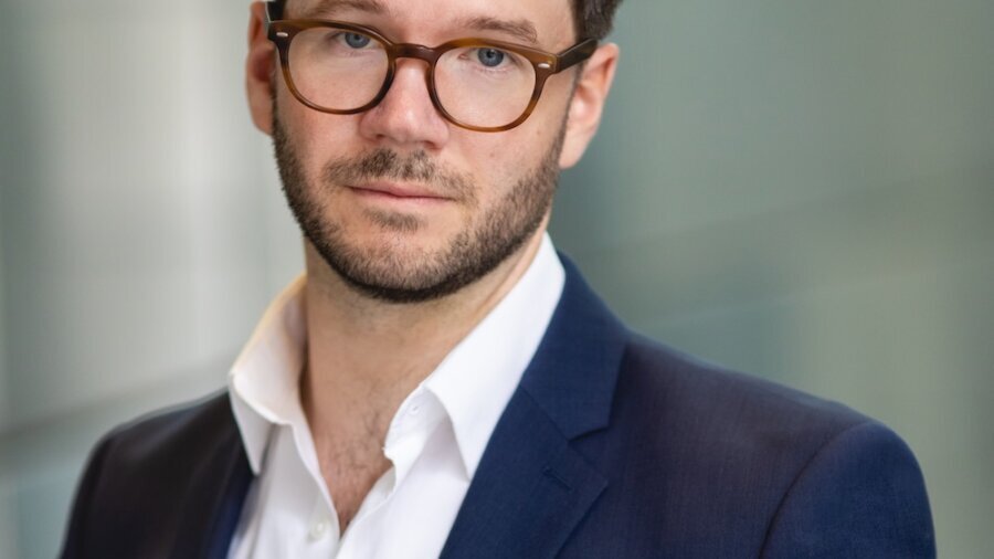 James Caverly headshot wearing a blue blazer