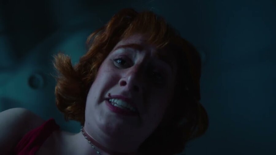 still from Do No Harm with a person with long red hair in the dark