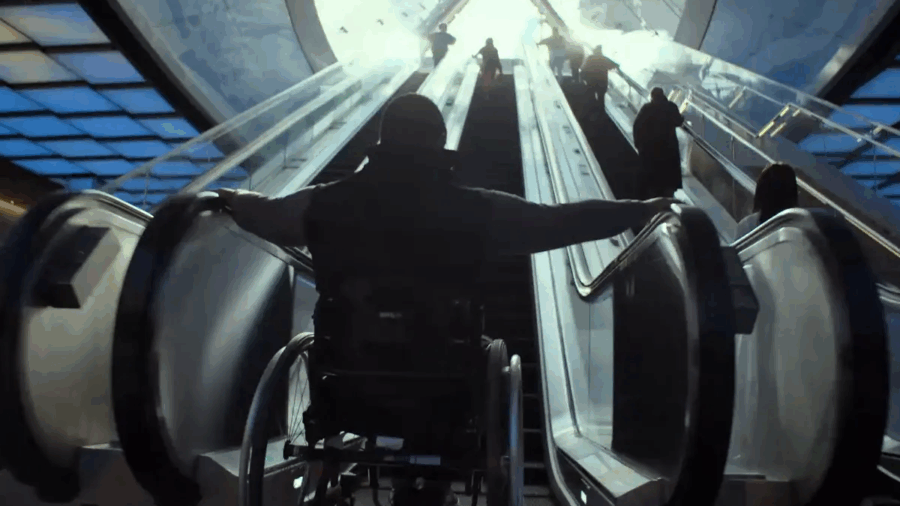 key art for Rising Phoenix with person in a wheelchair at the bottom of an escalator looking up towards the top